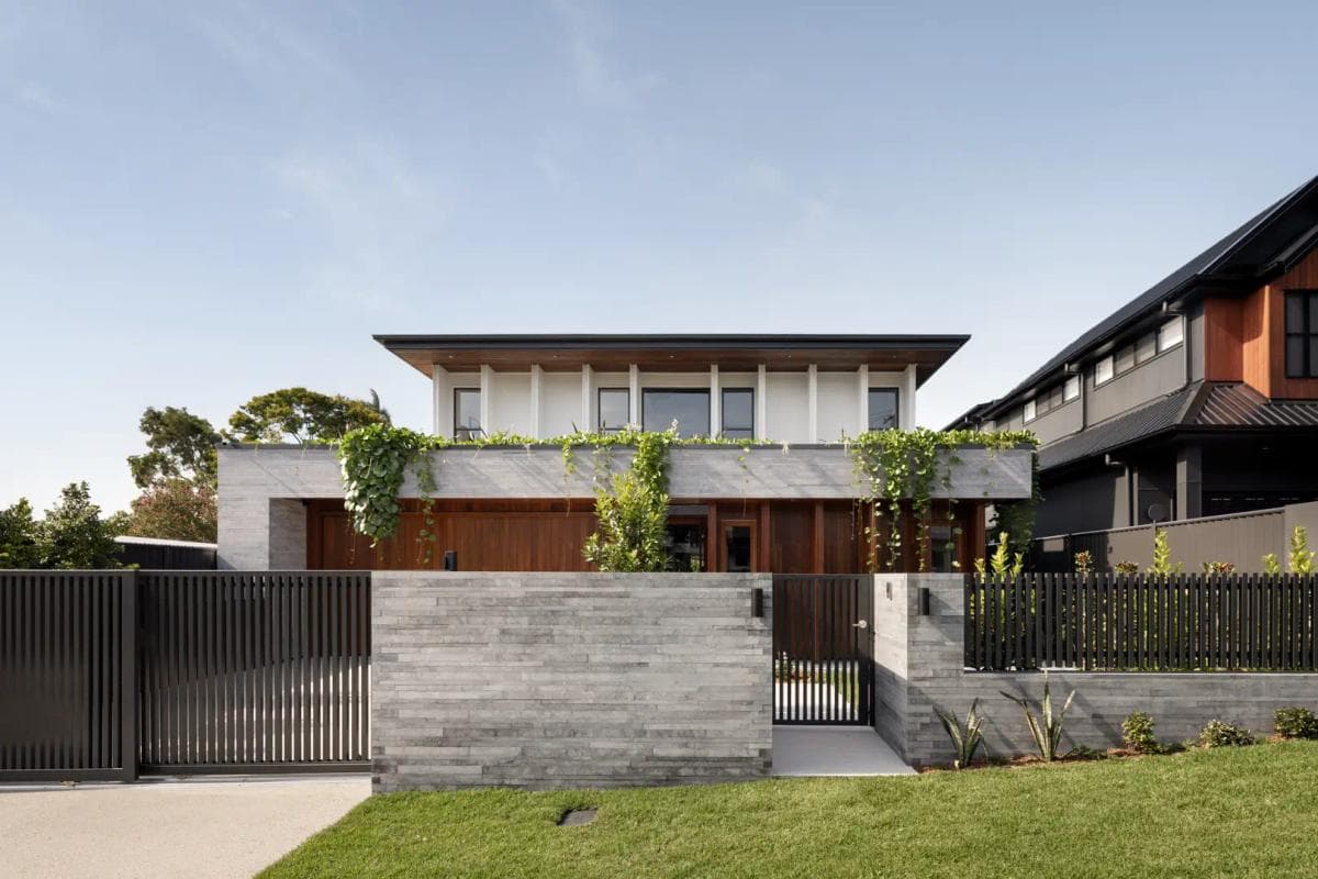 Street facade of Akala House behind its timber gate and stone fence